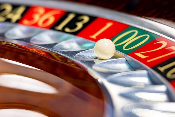 Live dealer at a Macau Pools table, cards mid-deal, professional studio background